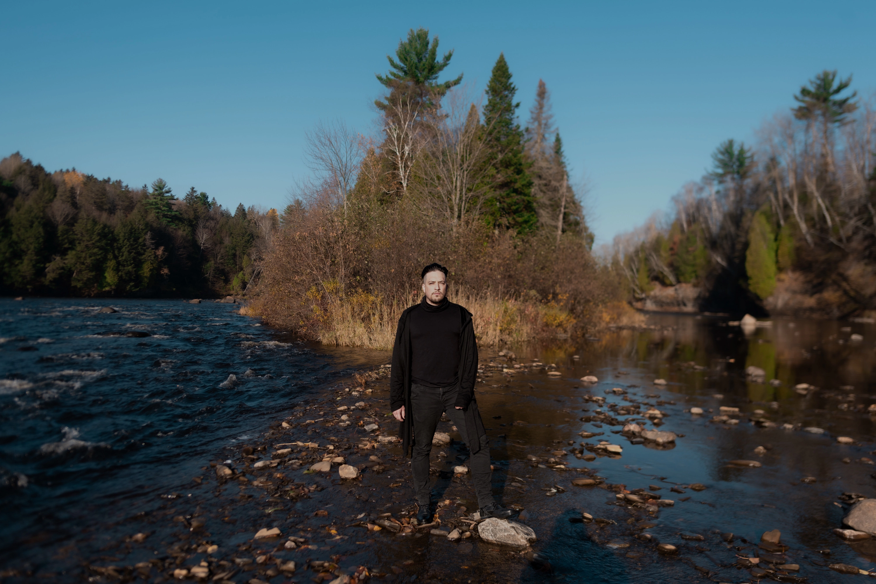 Photo of David Brongo standing at the edge of a river